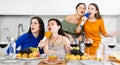 Cheerful female friends singing together at home karaoke Royalty Free Stock Photo