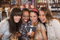 Cheerful female friends taking selfie in pub Royalty Free Stock Photo