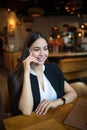 Cheerful female manager talking via cell telephone,resting in cafe Royalty Free Stock Photo