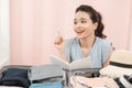 Cheerful Female Packing Suitcase And Getting Ready For Traveling Royalty Free Stock Photo