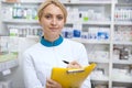 Cheerful female pharmacist working at the drugstore Royalty Free Stock Photo