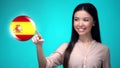 Cheerful female pushing Spanish flag button, ready to learn foreign language Royalty Free Stock Photo