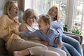 Cheerful female relatives having fun on home couch Royalty Free Stock Photo