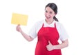 Cheerful female seller with empty paper showing thumbup