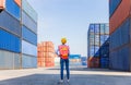 Cheerful female shipping company workers working at the harbor, Women engineer in hardhat and safety vest holding clipboard Royalty Free Stock Photo