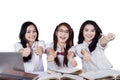 Cheerful female students with thumbs up Royalty Free Stock Photo