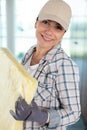 cheerful female worker holding insulation