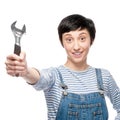 Cheerful female worker holding wrench Royalty Free Stock Photo