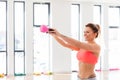 Cheerful, fit woman doing a kettlebell swing. Royalty Free Stock Photo