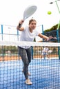 Young girl paddle tennis player performing forehand