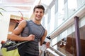 Cheerful fitness man with bottle of water walking on training Royalty Free Stock Photo