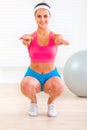 Cheerful fitness young girl doing exercises