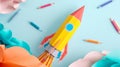 Vibrant flat lay of a pencil rocket with paper clouds and pencils on a light blue background. Royalty Free Stock Photo