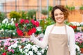 Cheerful florist presenting a flower