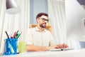 Cheerful freelancer in glasses working with pc and typing in office Royalty Free Stock Photo
