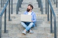 cheerful freelancer man has online laptop communication outdoor. freelancer man has online laptop