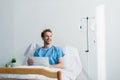 cheerful freelancer in patient gown using