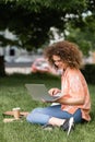 cheerful freelancer woman with curly hair