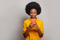 Cheerful friendly-looking woman messaging, browsing internet, using smartphone and shopping on white background