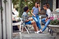 Cheerful friends chatting at the bar`s backyard. Quality friendship time together Royalty Free Stock Photo