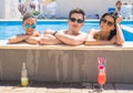 Cheerful friends drinking cocktails in the pool Royalty Free Stock Photo