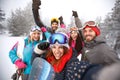 Friends with hands up on skiing Royalty Free Stock Photo