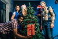 Friends makes fun on Christmas holyday with christmas tree