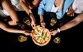 Cheerful friends in the pub. Drinking beer, eating pizza, talking, having fun. Royalty Free Stock Photo