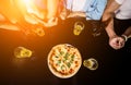 Cheerful friends in the pub. Drinking beer, eating pizza, talking, having fun. Royalty Free Stock Photo