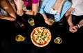 Cheerful friends in the pub. Drinking beer, eating pizza, talking, having fun. Royalty Free Stock Photo