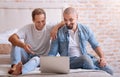 Cheerful friends sitting in front of the laptop Royalty Free Stock Photo