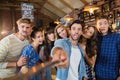 Cheerful friends taking selfie in pub Royalty Free Stock Photo