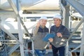 cheerful fuel chemical workers working at refinery plant Royalty Free Stock Photo