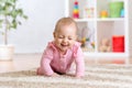 Cheerful funny baby crawling indoors at home Royalty Free Stock Photo