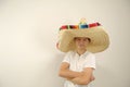 Cheerful and funny boy with a Mexican sambrero on a yellow background Royalty Free Stock Photo