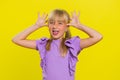 Cheerful funny bully child girl showing tongue making silly faces, fooling around, joking, teasing Royalty Free Stock Photo