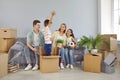 Cheerful funny family playing and having fun in their new house full of cardboard boxes Royalty Free Stock Photo