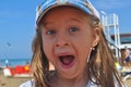 Cheerful funny little girl in a cap