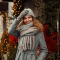 Cheerful funny young woman with a smile in a fashion gray coat