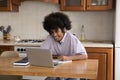 Cheerful fuzzy haired Black student studying from home Royalty Free Stock Photo