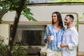 cheerful gay couple holding cups of Royalty Free Stock Photo