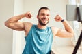 Handsome young man showing biceps muscles and smiling Royalty Free Stock Photo