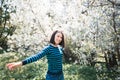 Cheerful girl in blooming garden. Spring mood. Sunny young woman