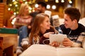 Girl and boy listening music on tablet together Royalty Free Stock Photo