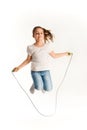 Cheerful girl in casual clothes jumping on rope Royalty Free Stock Photo