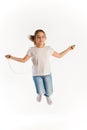 Cheerful girl in casual clothes jumping on rope Royalty Free Stock Photo