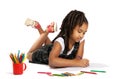 Cheerful girl draws pencil lying on the floor Royalty Free Stock Photo