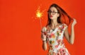 Cheerful girl holds in the hand a burning Bengal fire with spark Royalty Free Stock Photo