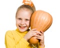 Cheerful girl hugs a pumpkin Royalty Free Stock Photo