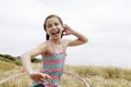 Cheerful Girl Hula Hooping In Field